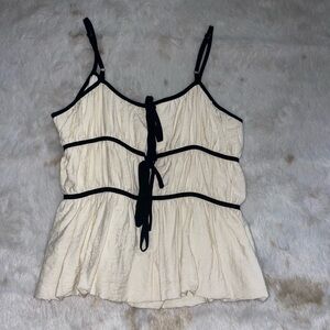 Elegant Cream Sleeveless Top with Black Tie Front